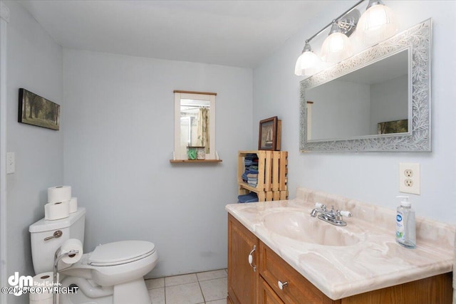 bathroom featuring toilet, vanity, and tile patterned flooring