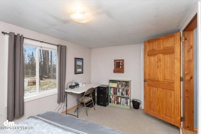 carpeted bedroom featuring a textured ceiling