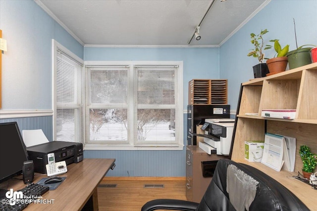 office with visible vents, rail lighting, a wainscoted wall, and ornamental molding