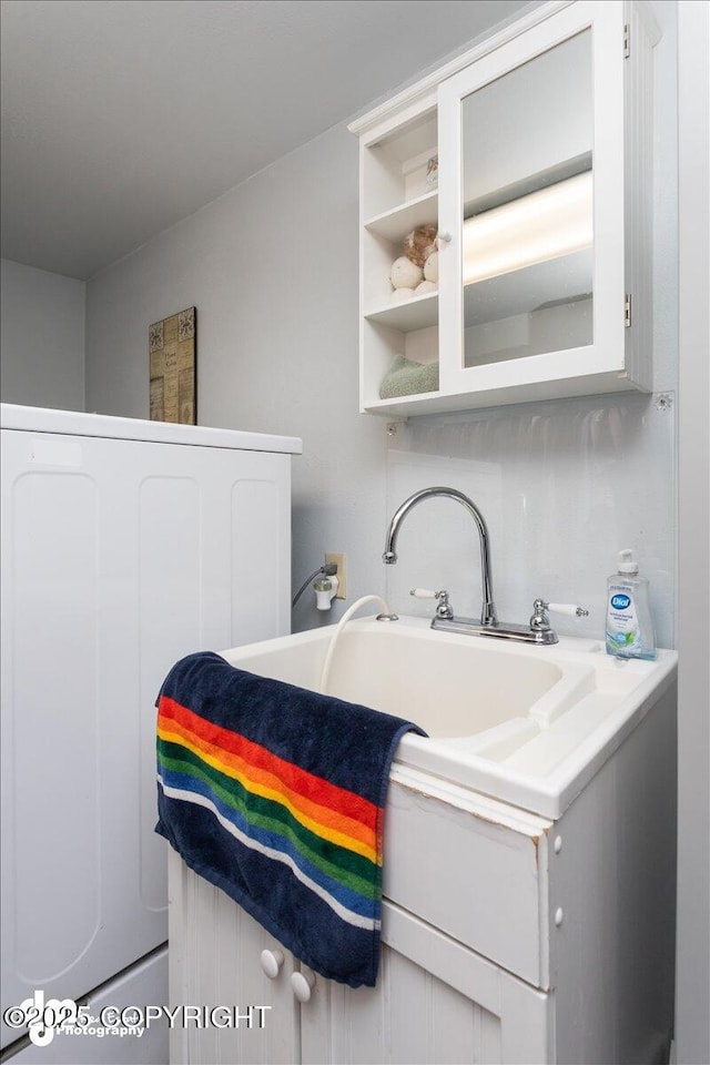 bathroom with washer / clothes dryer and vanity