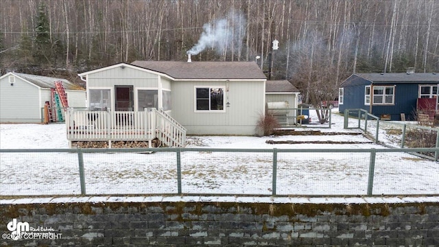 view of front of property with a fenced backyard, a shed, and an outdoor structure