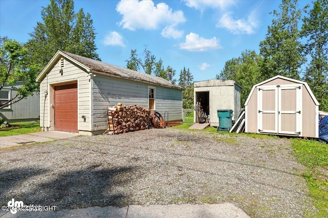 10833 E Twin Peaks Ct, Palmer, AK 99645 - detached garage with a storage shed and driveway