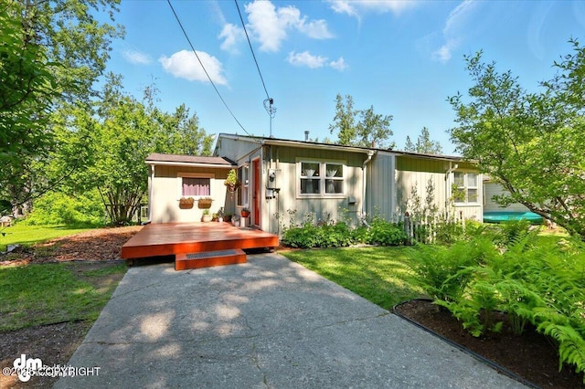 10833 E Twin Peaks Ct, Palmer, AK 99645 - view of front facade with a deck, board and batten siding, and a front lawn
