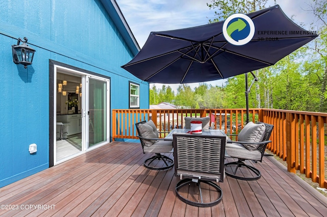 wooden deck featuring outdoor dining space