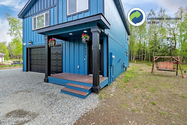 view of property exterior with gravel driveway, a garage, and board and batten siding