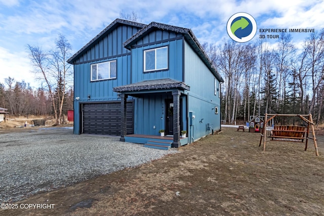 view of front of property with aphalt driveway, board and batten siding, and an attached garage