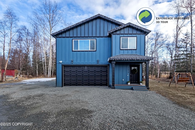 view of front of house featuring board and batten siding, gravel driveway, and an attached garage