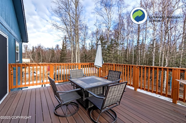 wooden deck featuring outdoor dining space