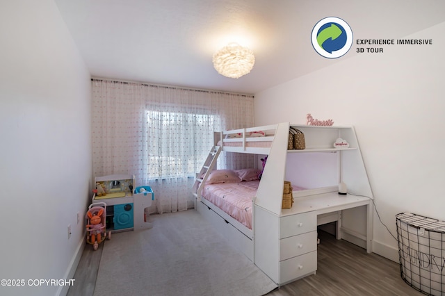 bedroom featuring baseboards and wood finished floors