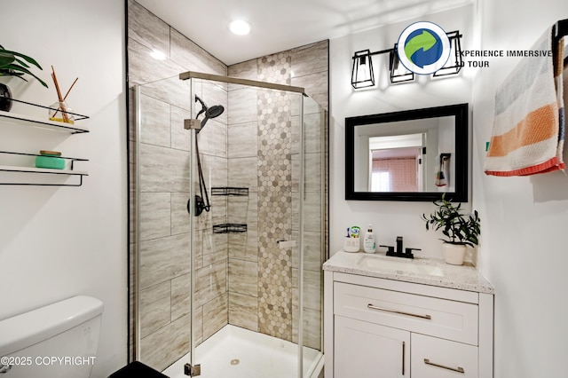 full bathroom with toilet, a shower stall, and vanity