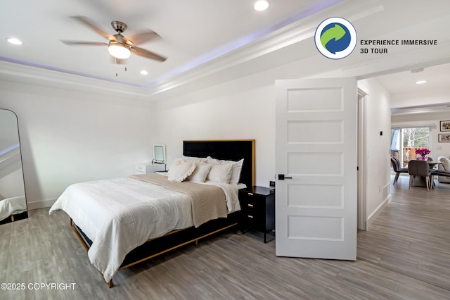 bedroom featuring baseboards, wood finished floors, and recessed lighting