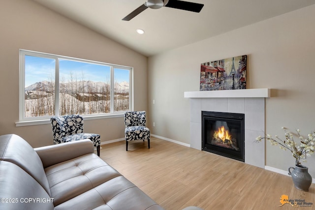 5991 Takotna Loop, Anchorage, AK 99504 - living area featuring ceiling fan, wood finished floors, a tiled fireplace, lofted ceiling, and recessed lighting