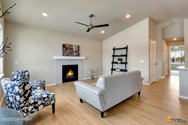 5991 Takotna Loop, Anchorage, AK 99504 - living room with vaulted ceiling, a ceiling fan, light wood-style flooring, a fireplace, and recessed lighting