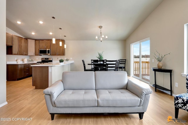5991 Takotna Loop, Anchorage, AK 99504 - living area with lofted ceiling, light wood-type flooring, a chandelier, and recessed lighting
