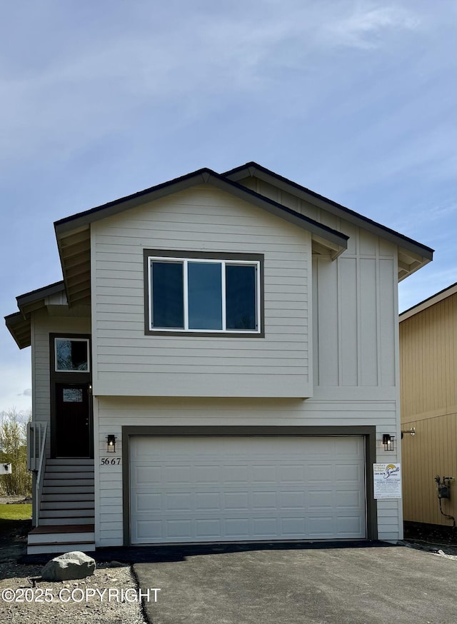5991 Takotna Loop, Anchorage, AK 99504 - view of front of property with an attached garage, driveway, and board and batten siding