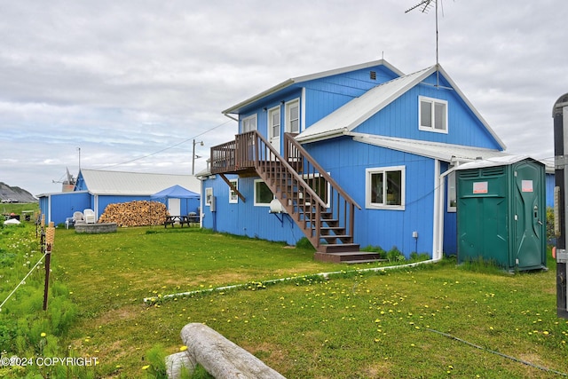 15264 Airport Ln, Ninilchik, AK 99639 - rear view of property featuring a yard, an outbuilding, a storage unit, and stairs