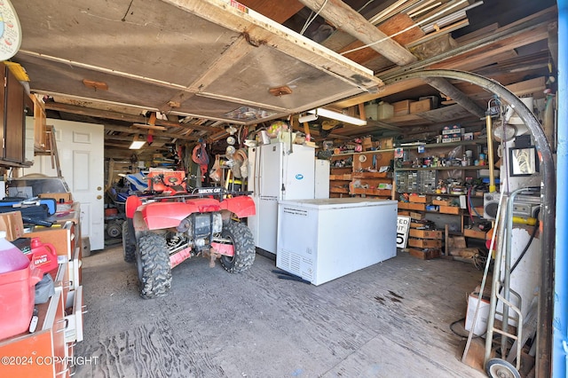 15264 Airport Ln, Ninilchik, AK 99639 - basement with fridge and a workshop area