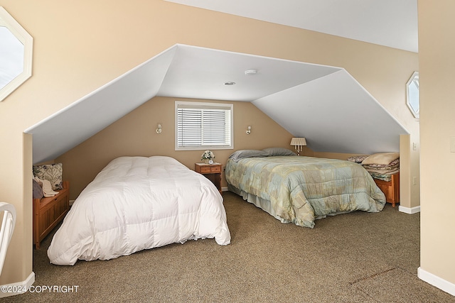 bedroom featuring vaulted ceiling and carpet flooring