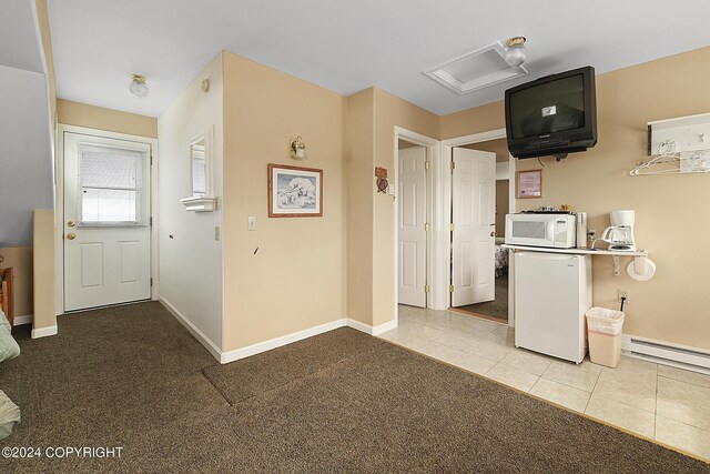 15264 Airport Ln, Ninilchik, AK 99639 - kitchen featuring baseboards, baseboard heating, white microwave, tile patterned flooring, and fridge