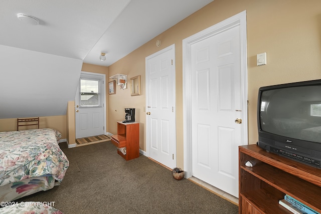 bedroom featuring dark carpet