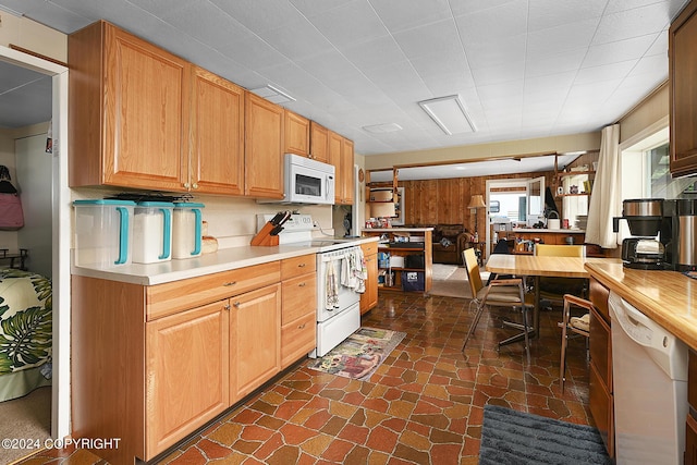 15264 Airport Ln, Ninilchik, AK 99639 - kitchen featuring light countertops, wood walls, and white appliances