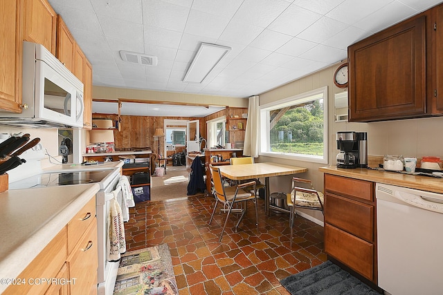 15264 Airport Ln, Ninilchik, AK 99639 - kitchen featuring light countertops, visible vents, wood walls, and white appliances