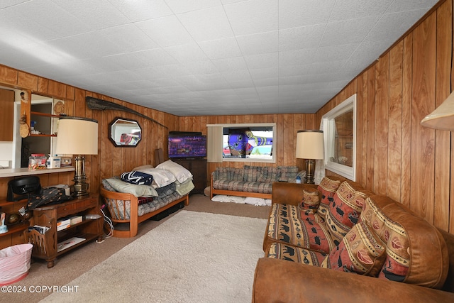 bedroom featuring wood walls and carpet flooring