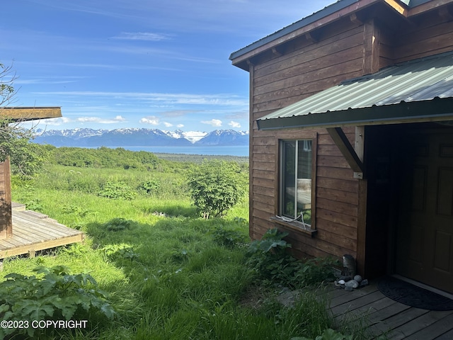 view of side of property with a deck with mountain view