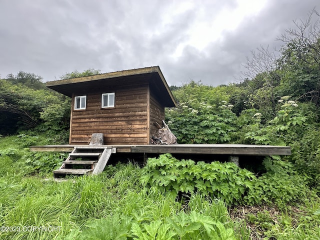 rear view of house featuring an outdoor structure