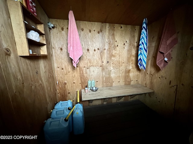 mudroom with wood ceiling, hardwood / wood-style floors, and wooden walls