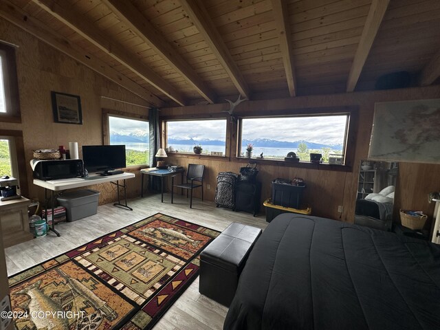 interior space featuring light hardwood / wood-style floors, wood ceiling, wood walls, and vaulted ceiling with beams