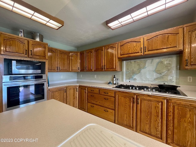 kitchen featuring tasteful backsplash and stainless steel appliances