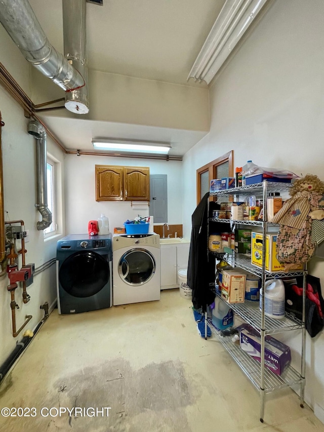 laundry area featuring sink, cabinets, and washing machine and clothes dryer