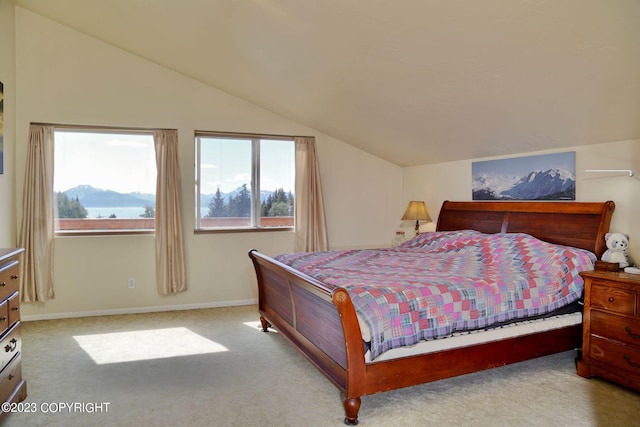 bedroom featuring light colored carpet and vaulted ceiling