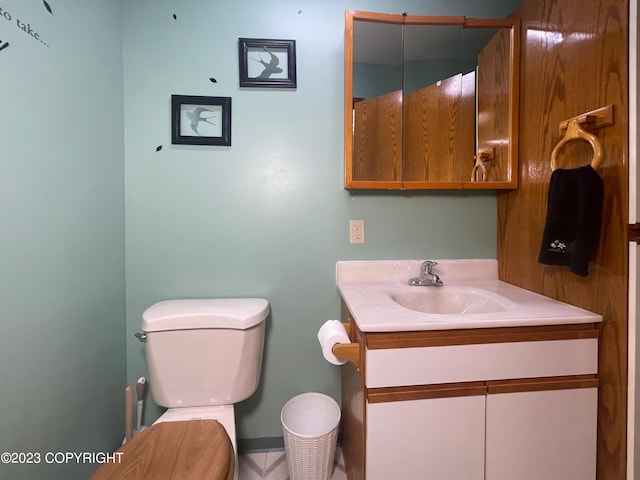 bathroom with vanity, tile flooring, and toilet