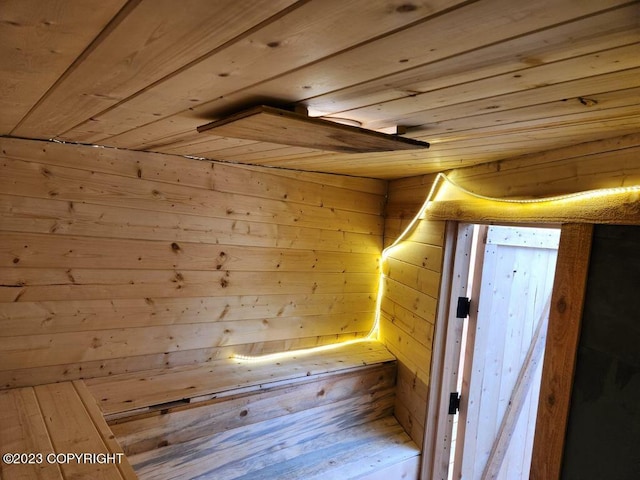 view of sauna with wooden walls and wooden ceiling