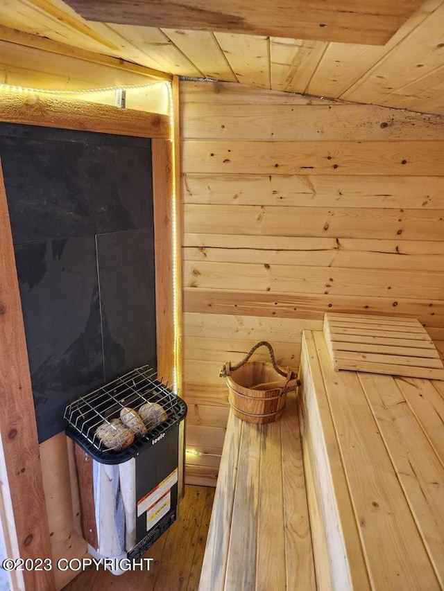 view of sauna / steam room featuring wood walls, wood ceiling, and hardwood / wood-style floors