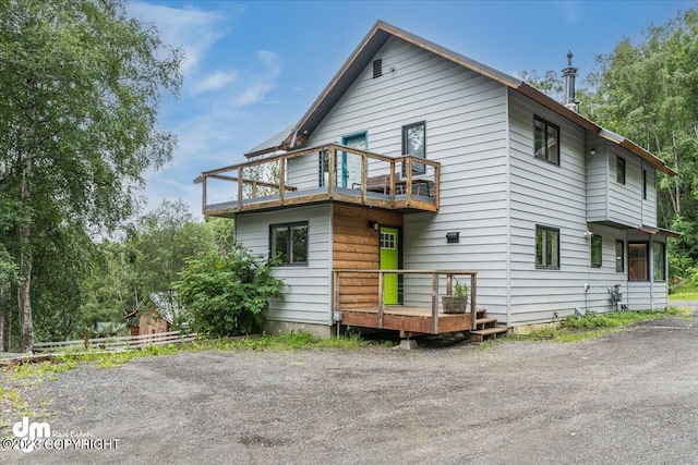 rear view of property featuring a balcony