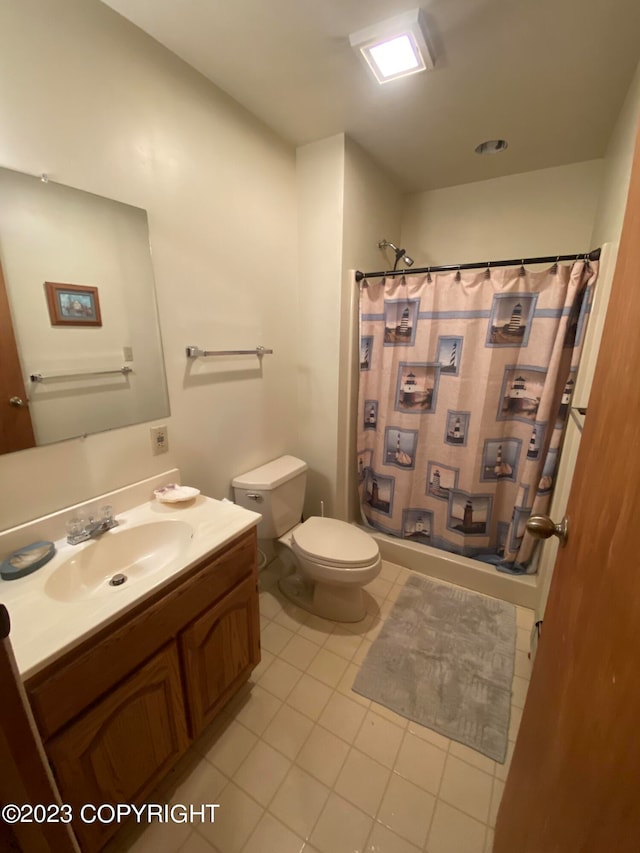 bathroom with curtained shower, toilet, vanity, and tile patterned flooring