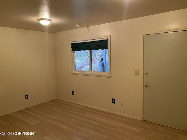 unfurnished room with light wood-type flooring