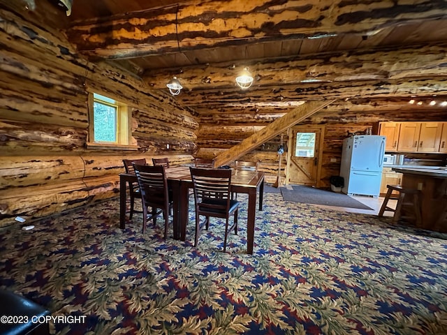 344 Eagle Bluff Dr, Haines, AK 99827 - dining area featuring beam ceiling, log walls, carpet floors, and wooden ceiling