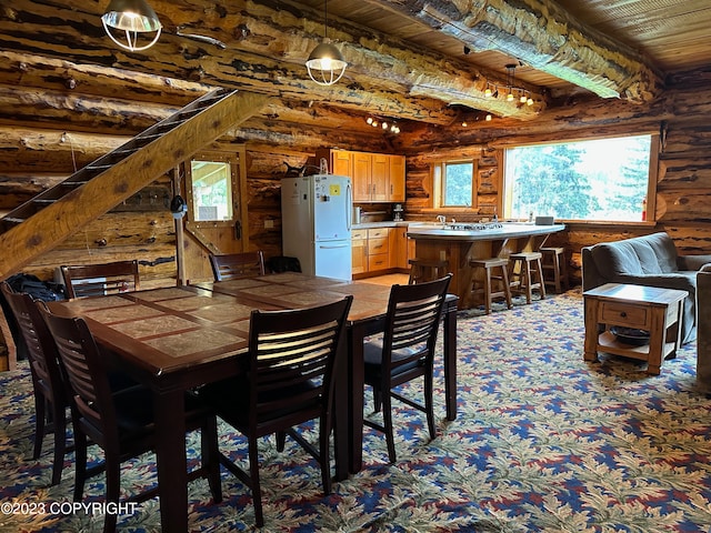 344 Eagle Bluff Dr, Haines, AK 99827 - dining area featuring wood ceiling, log walls, beamed ceiling, and light colored carpet