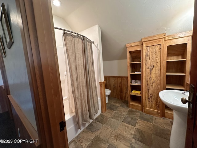 344 Eagle Bluff Dr, Haines, AK 99827 - full bath with shower / bathtub combination with curtain, wood walls, lofted ceiling, toilet, and wainscoting