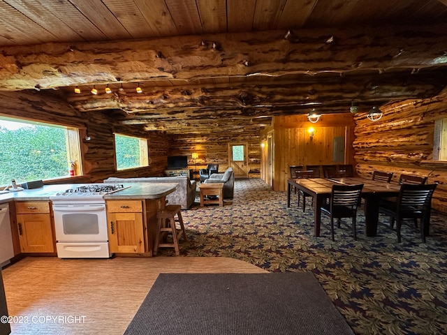 344 Eagle Bluff Dr, Haines, AK 99827 - kitchen with electric panel, beamed ceiling, white appliances, open floor plan, and wooden ceiling