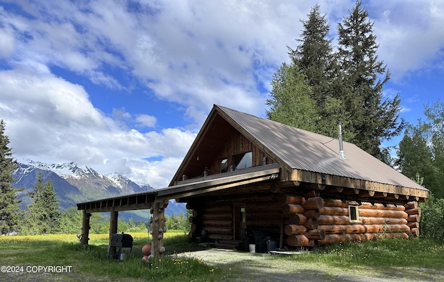 344 Eagle Bluff Dr, Haines, AK 99827 - view of side of home featuring an outbuilding, a mountain view, metal roof, and log exterior