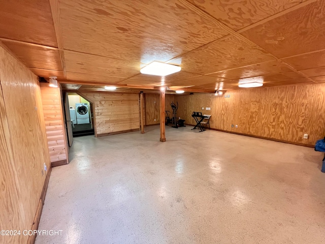 basement with washer / dryer and wooden walls