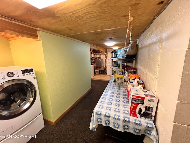 laundry area featuring washer / clothes dryer, water heater, and dark colored carpet