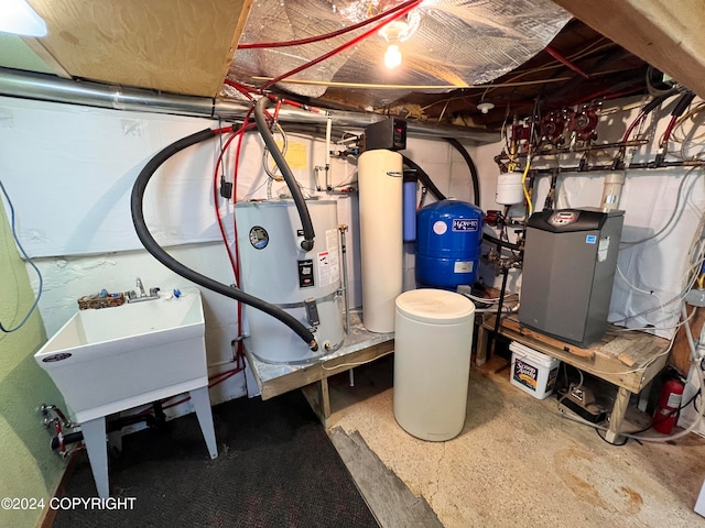 utilities featuring strapped water heater and sink