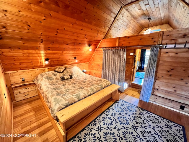 bedroom with lofted ceiling, light wood-type flooring, wood ceiling, and wood walls