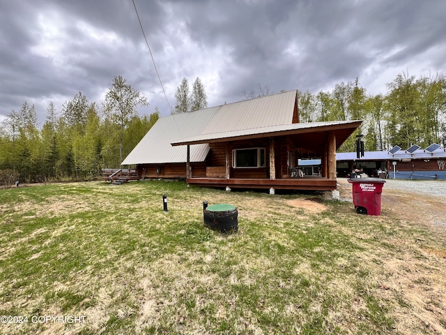 back of house featuring a lawn